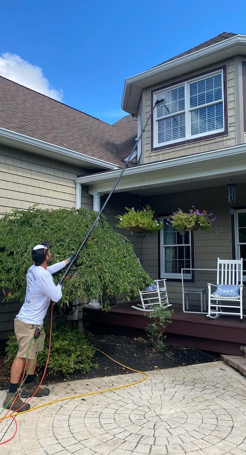 Pressure washing siding of house