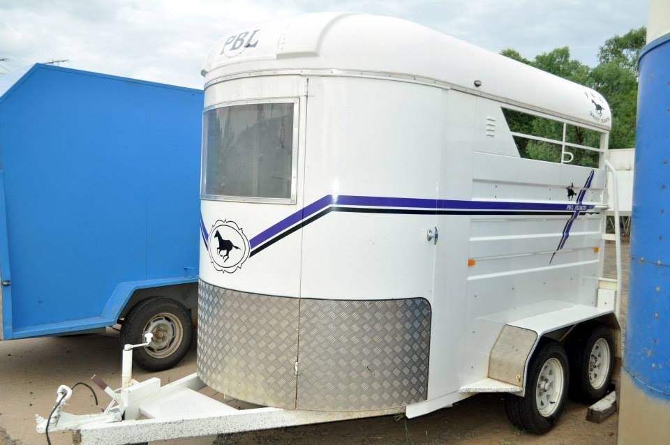 A White Horse Trailer is Parked Next to a Blue Trailer — Locqal Car Truck Trailer Rentals in Emerald, QLD