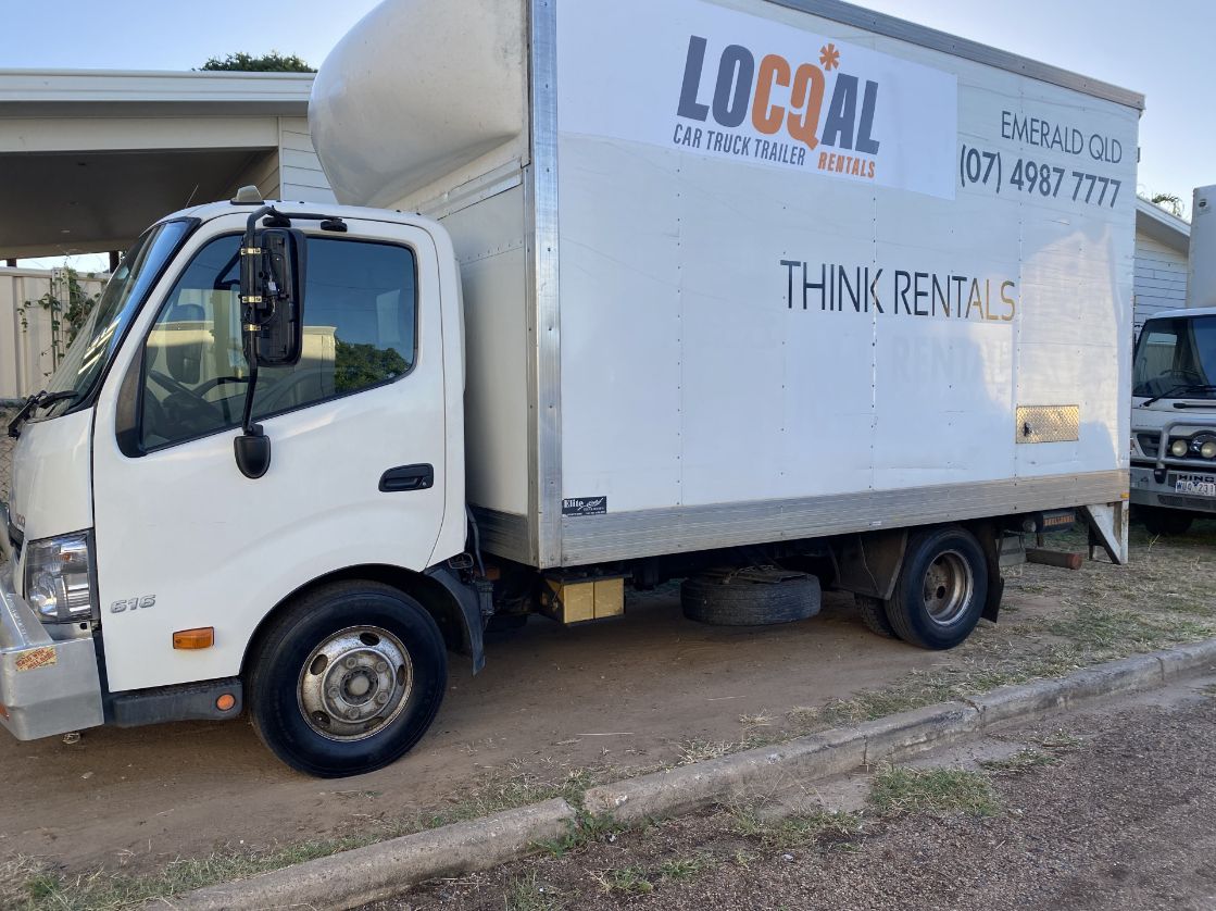 A White Moving Truck Is Parked on The Side of The Road — Locqal Car Truck Trailer Rentals in Emerald, QLD