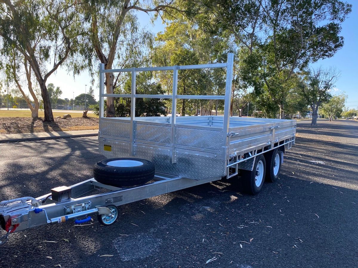 A white moving truck is parked on the side of the road.