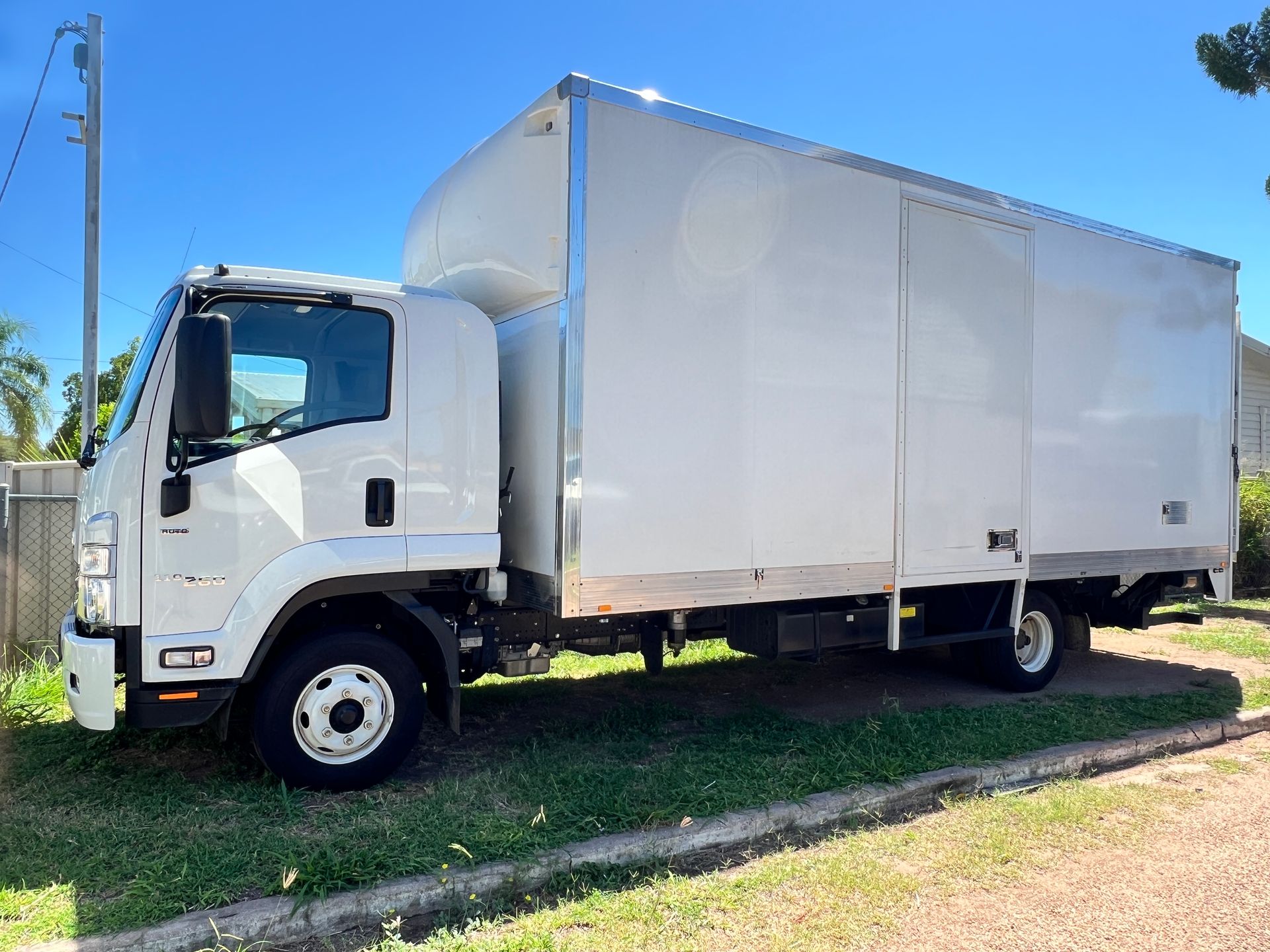 A White Moving Truck is Parked on the Side of the Road — Locqal Car Truck Trailer Rentals in Emerald, QLD