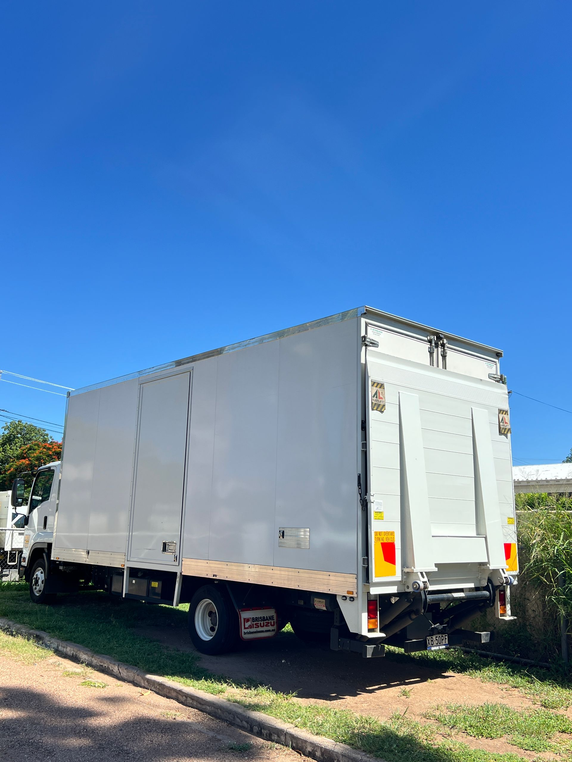 A White Truck is Parked on the Side of the Road — Locqal Car Truck Trailer Rentals in Emerald, QLD