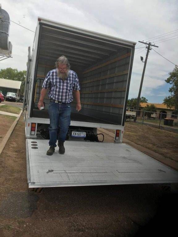 A Man in A Plaid Shirt Is Walking out Of a Truck — Locqal Car Truck Trailer Rentals in Emerald, QLD