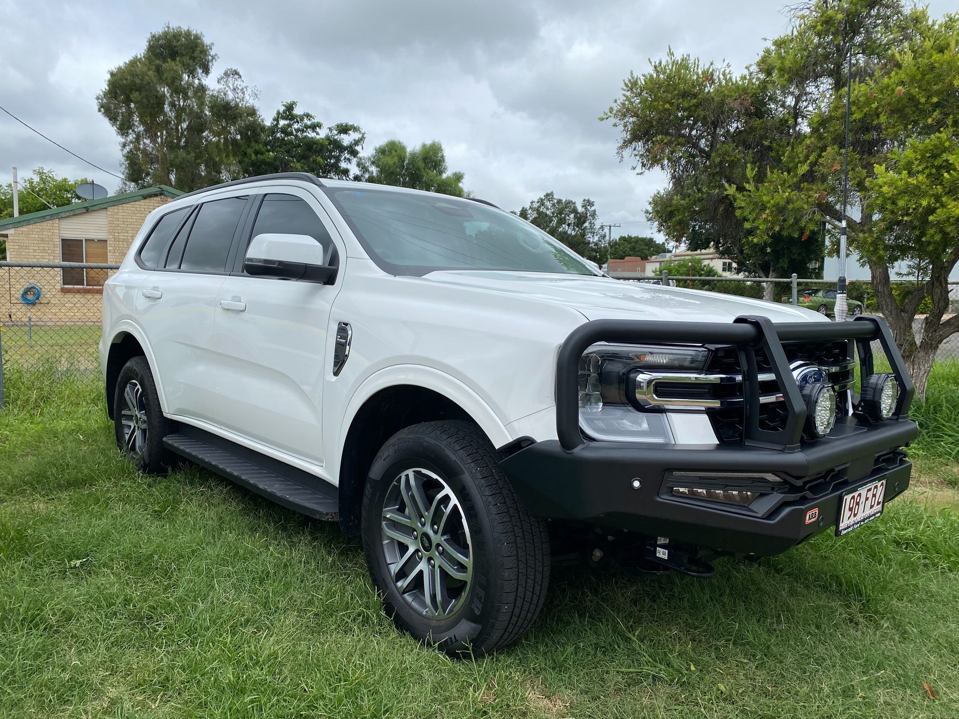 White SUV Parked on Grass Ready for Hire