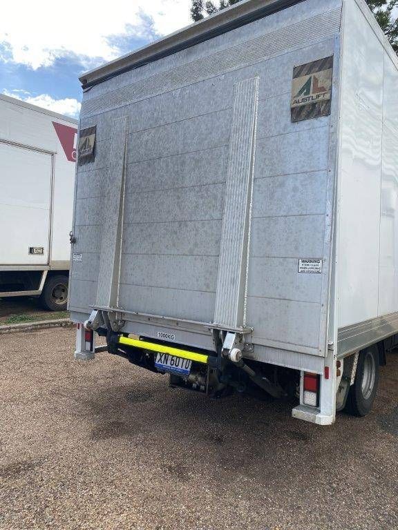 A White Truck with The Back Door Open Is Parked in A Gravel Lot — Locqal Car Truck Trailer Rentals in Emerald, QLD