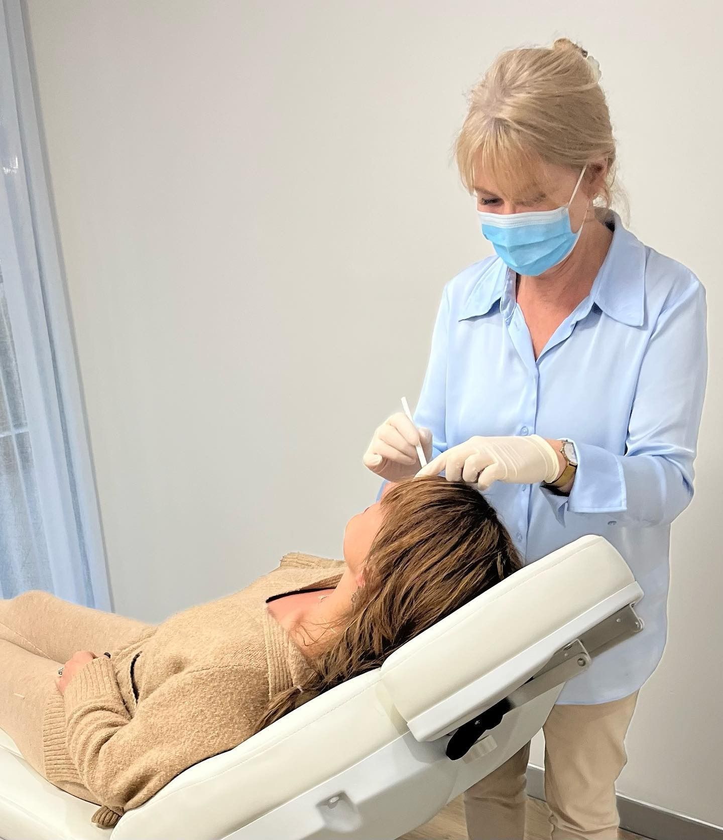 Woman Performing a Cosmestic Procedure