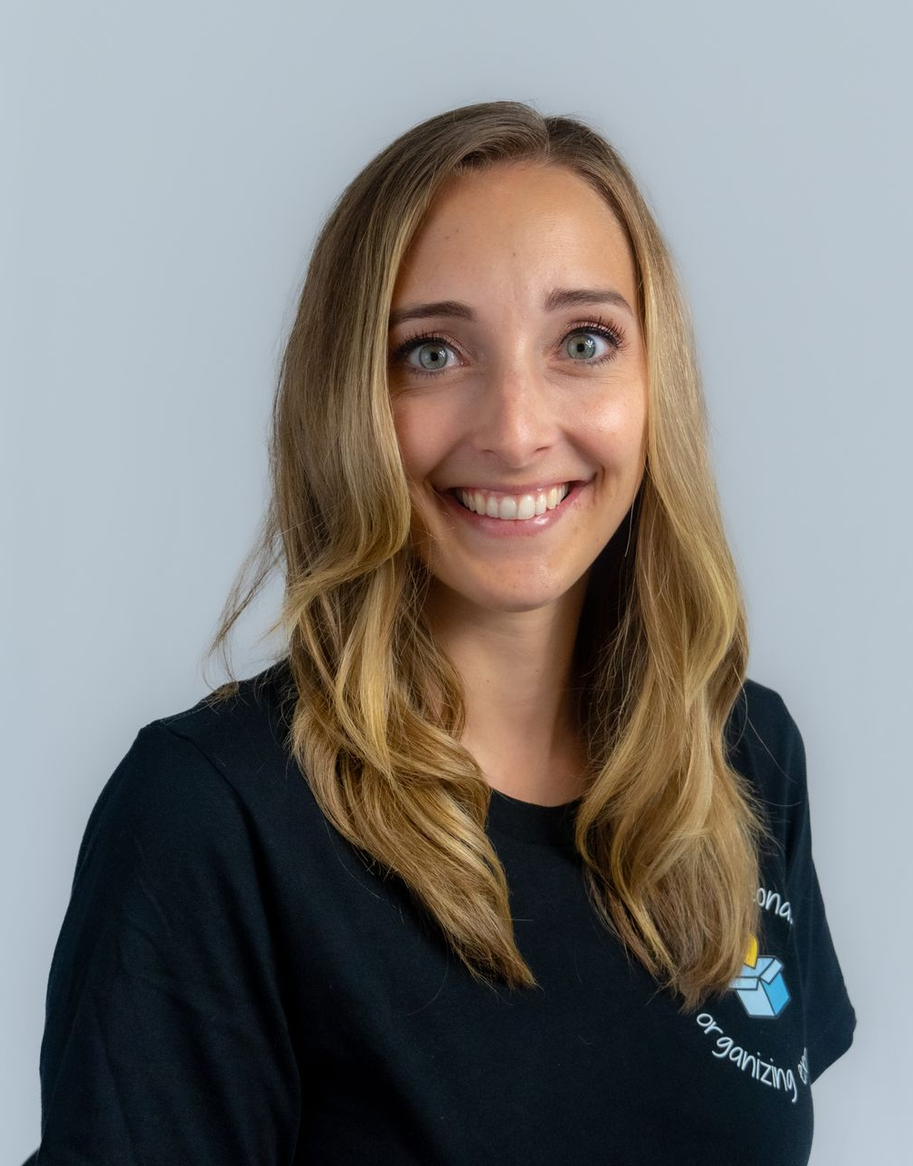 Woman with blonde hair and black shirt smiling