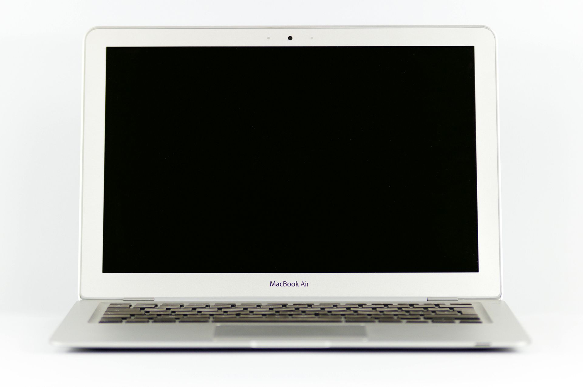 A white dell laptop with a black screen