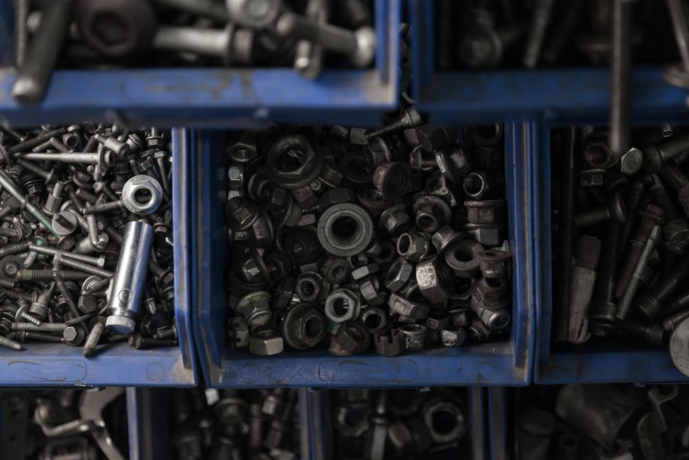 there are many different types of nuts and bolts in the bins .