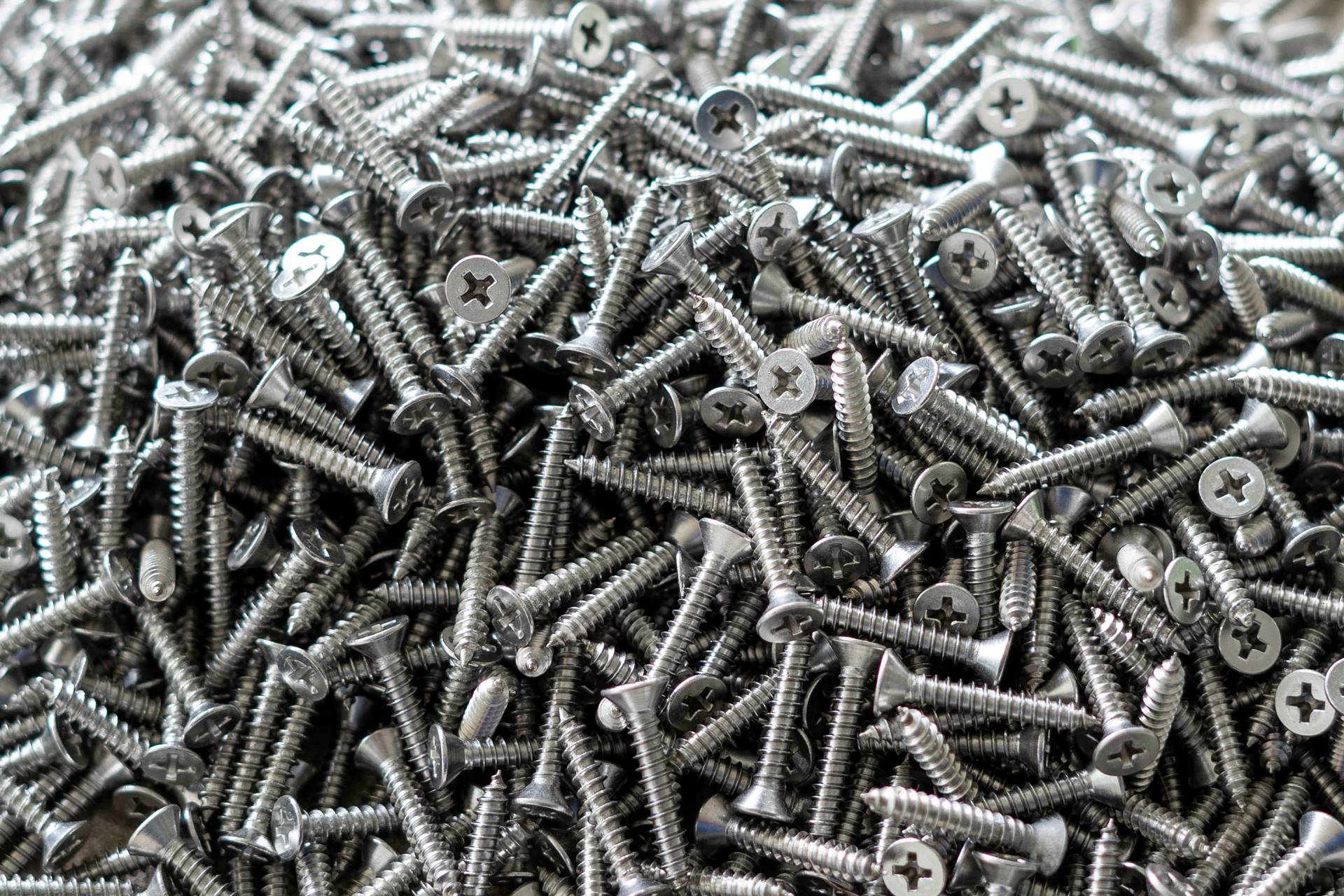 a pile of screws sitting on top of each other on a table .