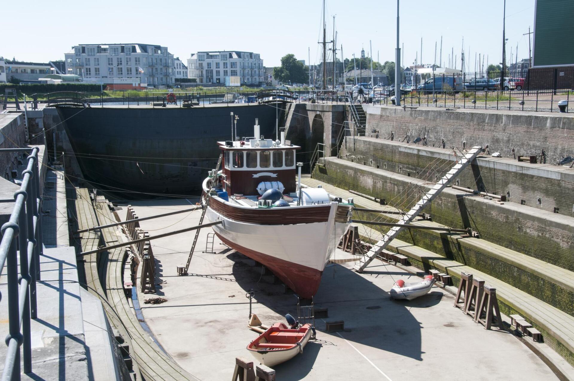 men sandblasting a boat