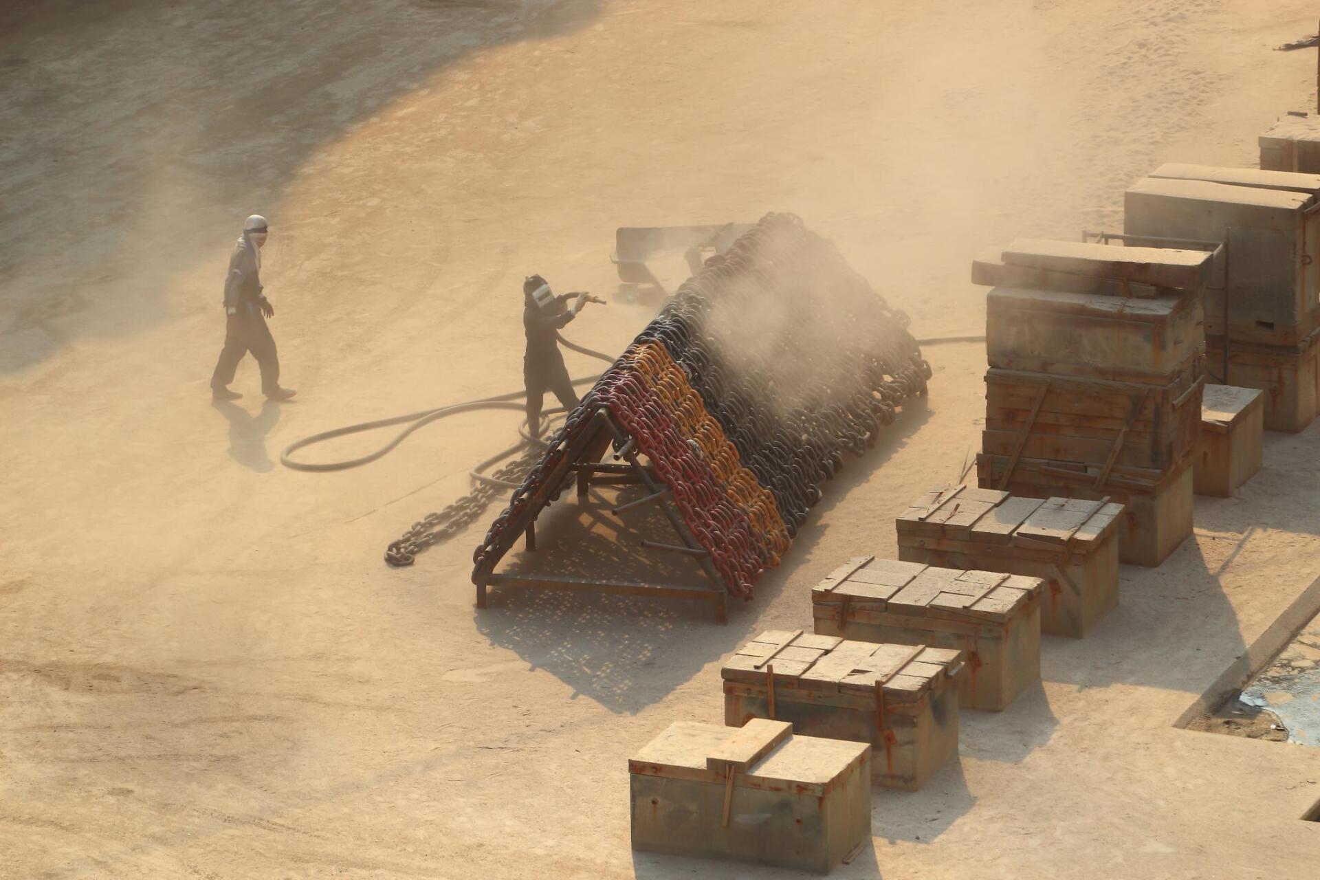 men doing sandblasting job