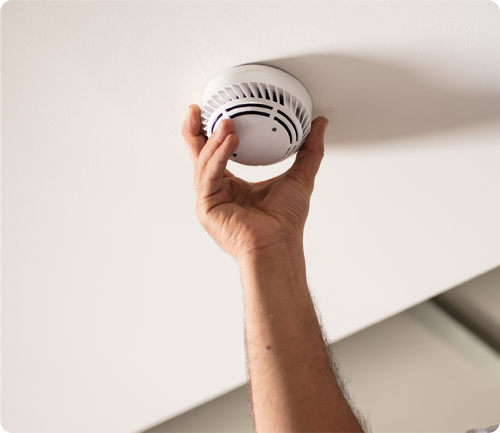A person is pressing a button on a fingerprint scanner.