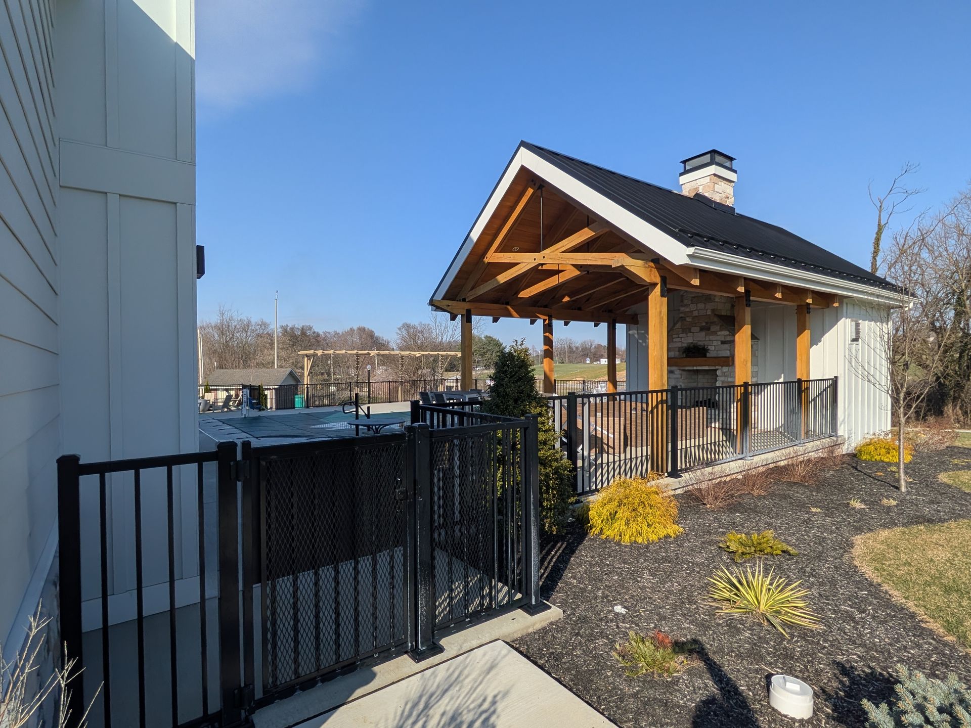 Community pool enclosed with code-compliant aluminum fencing by Millcreek Fence