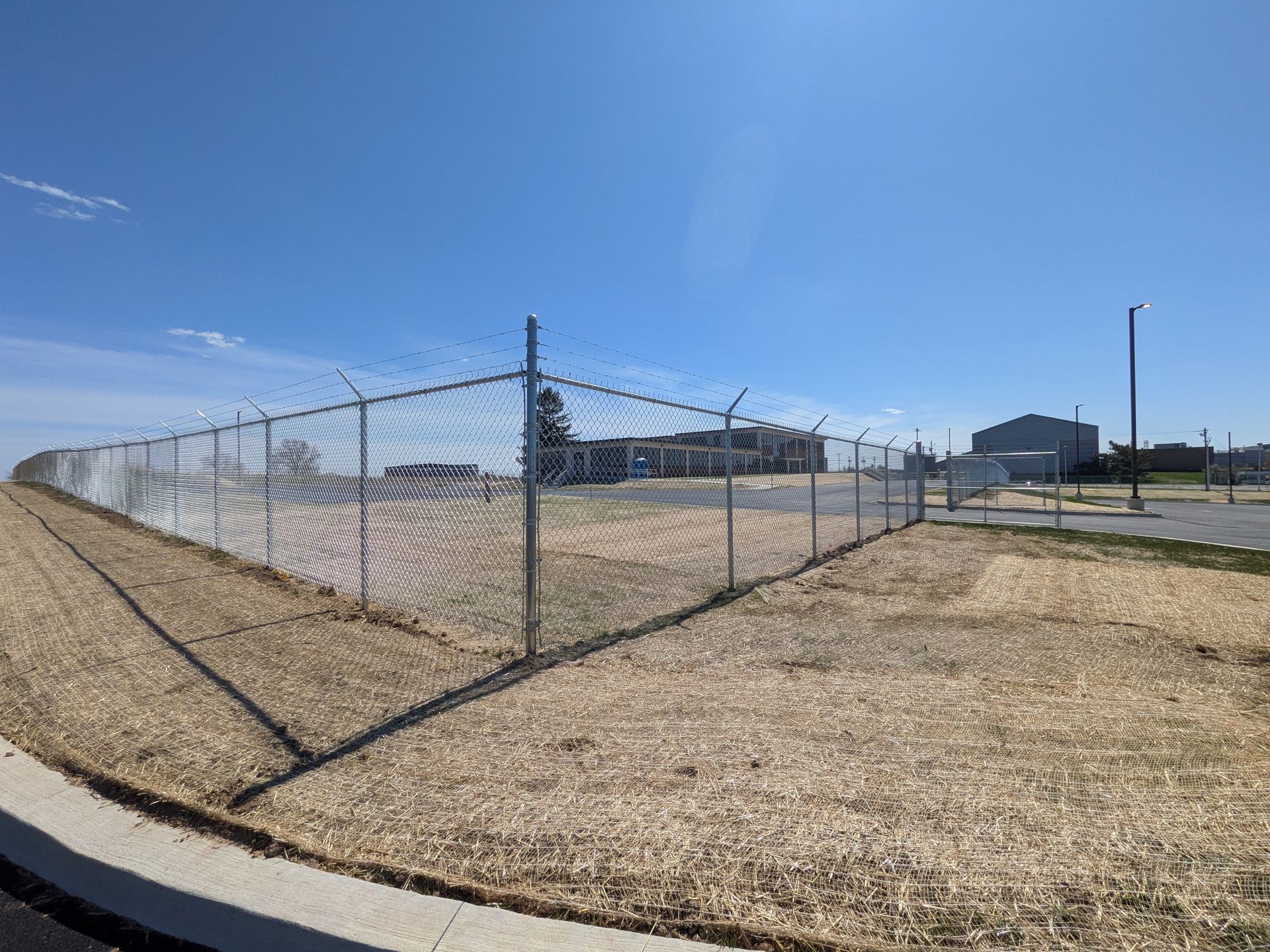 Delaware Army National Guard facility, featuring 8 ft chain link fencing and barbed wire. 