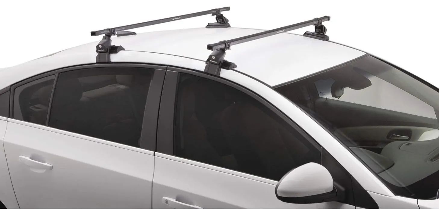 White car with black roof rack installed.