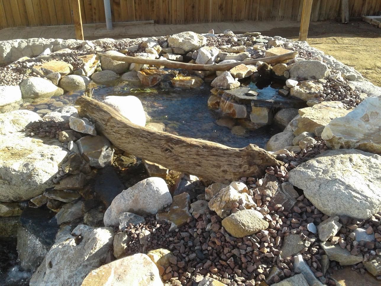 A rocky area with a fire pit in the middle