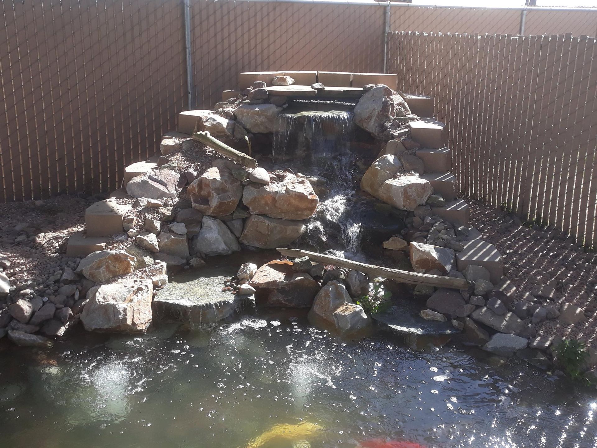 A pond with a waterfall in the middle of it