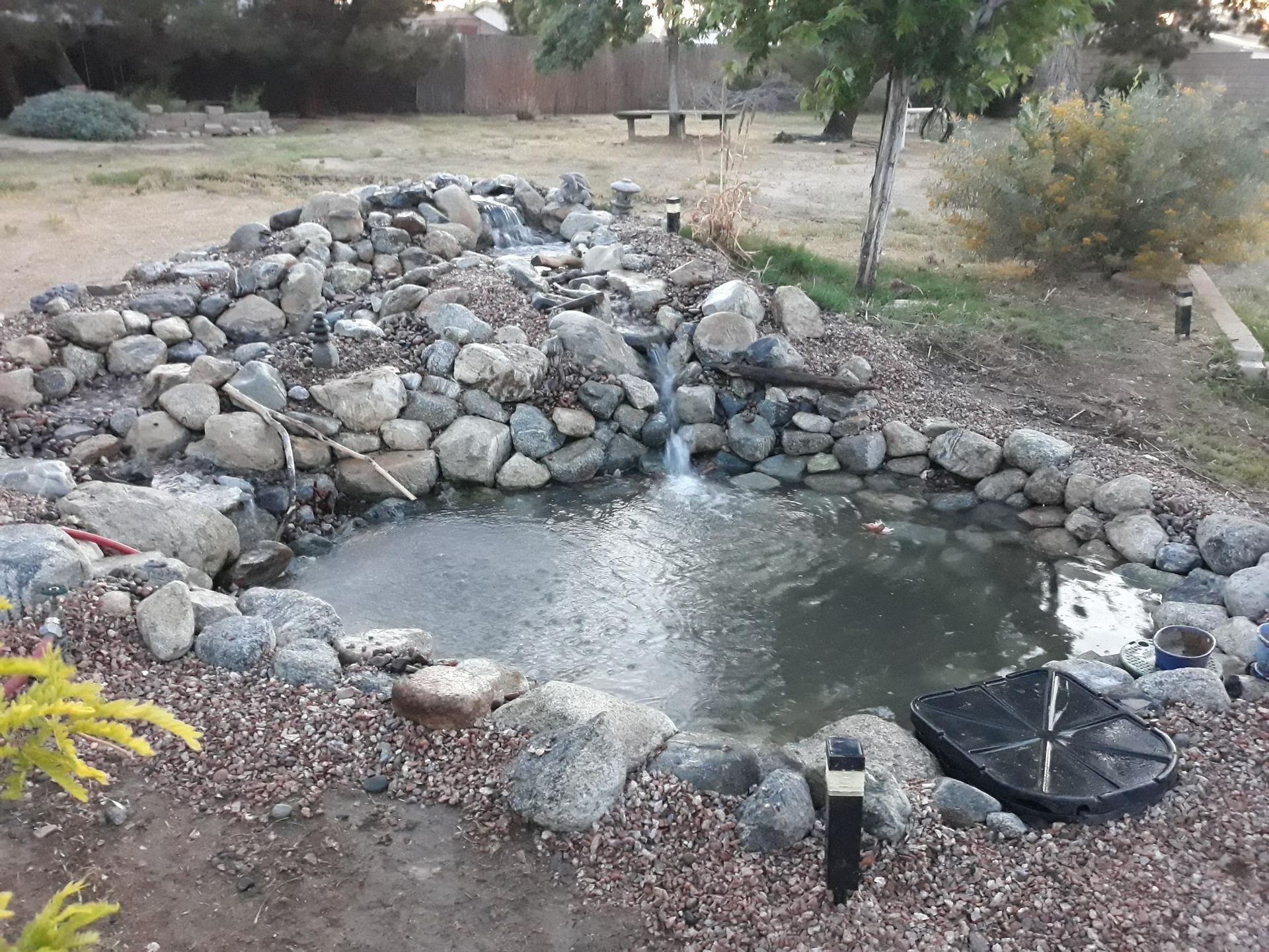 A pond with a waterfall in the middle of it