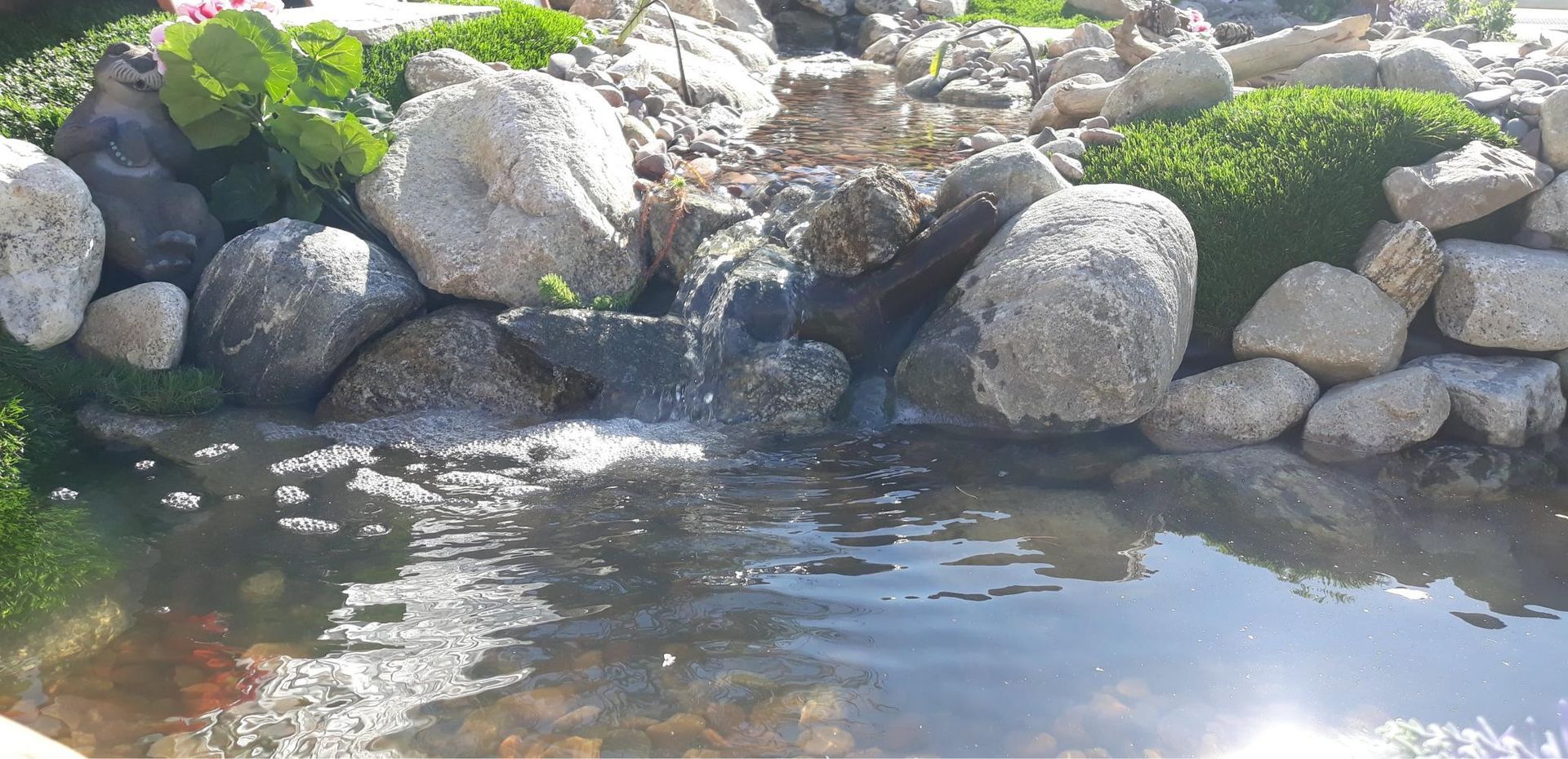 A pond with a waterfall in the middle of it