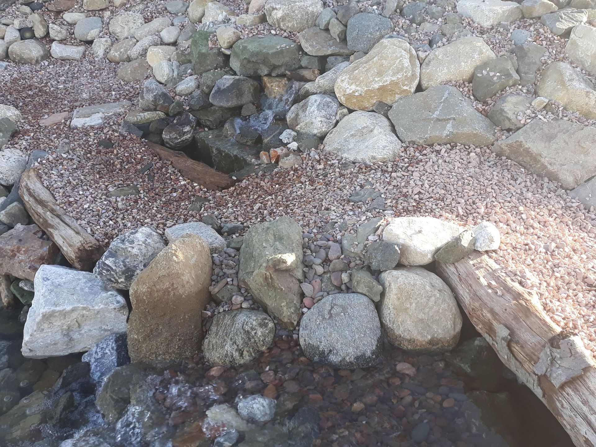 A pile of rocks sitting on top of a pile of gravel.