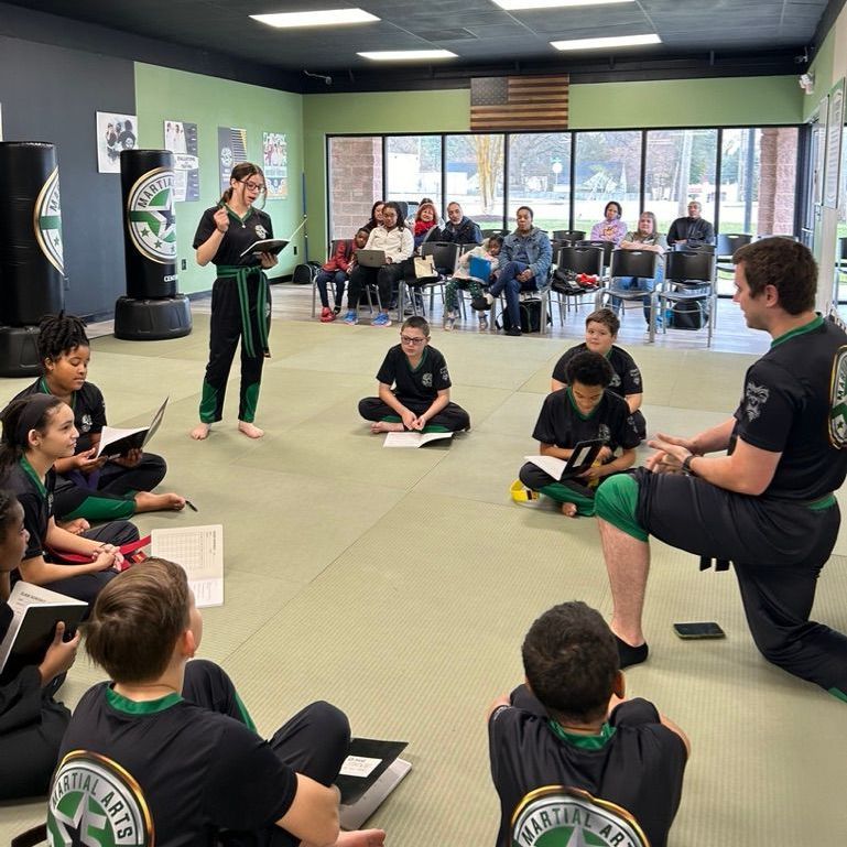 A group of men are practicing karate in a gym.