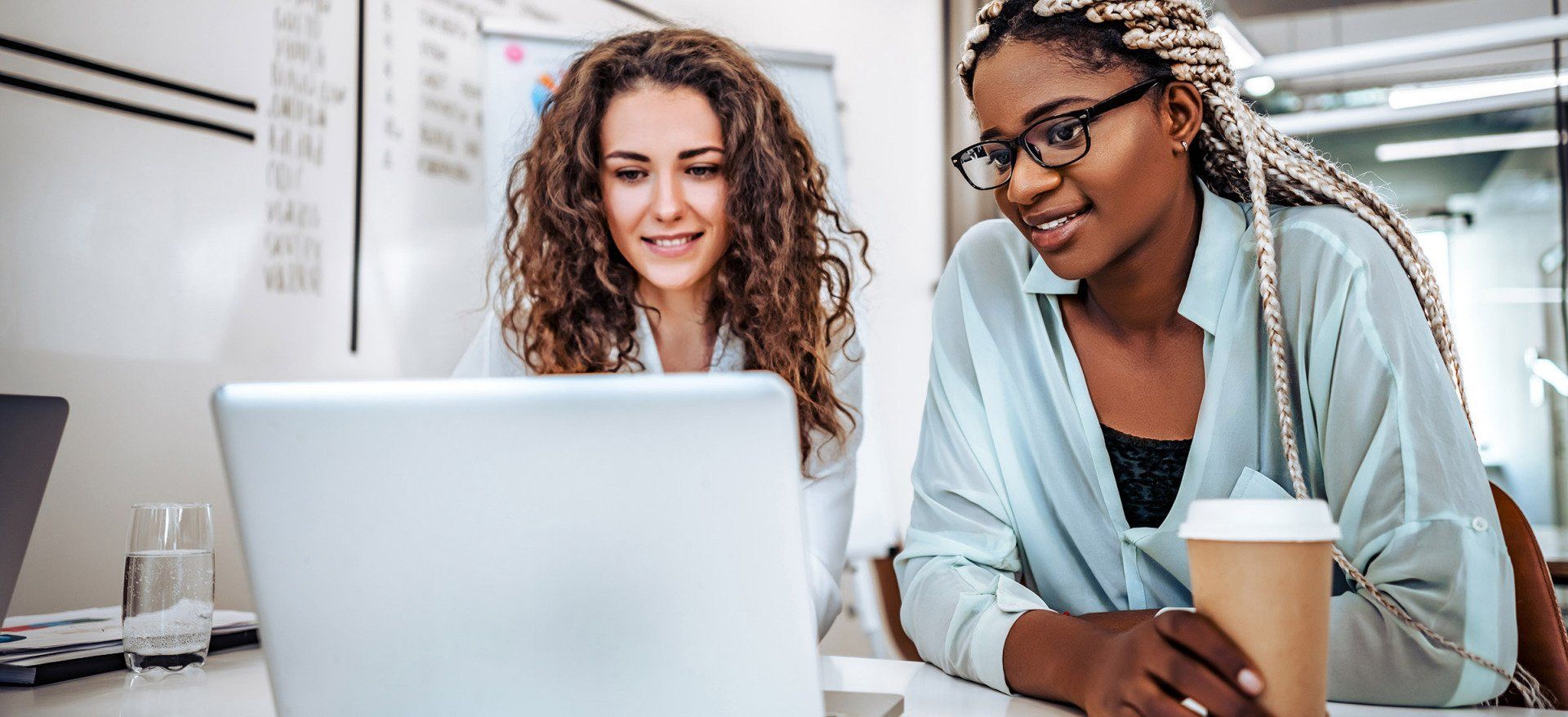 Two team members looking at a computer