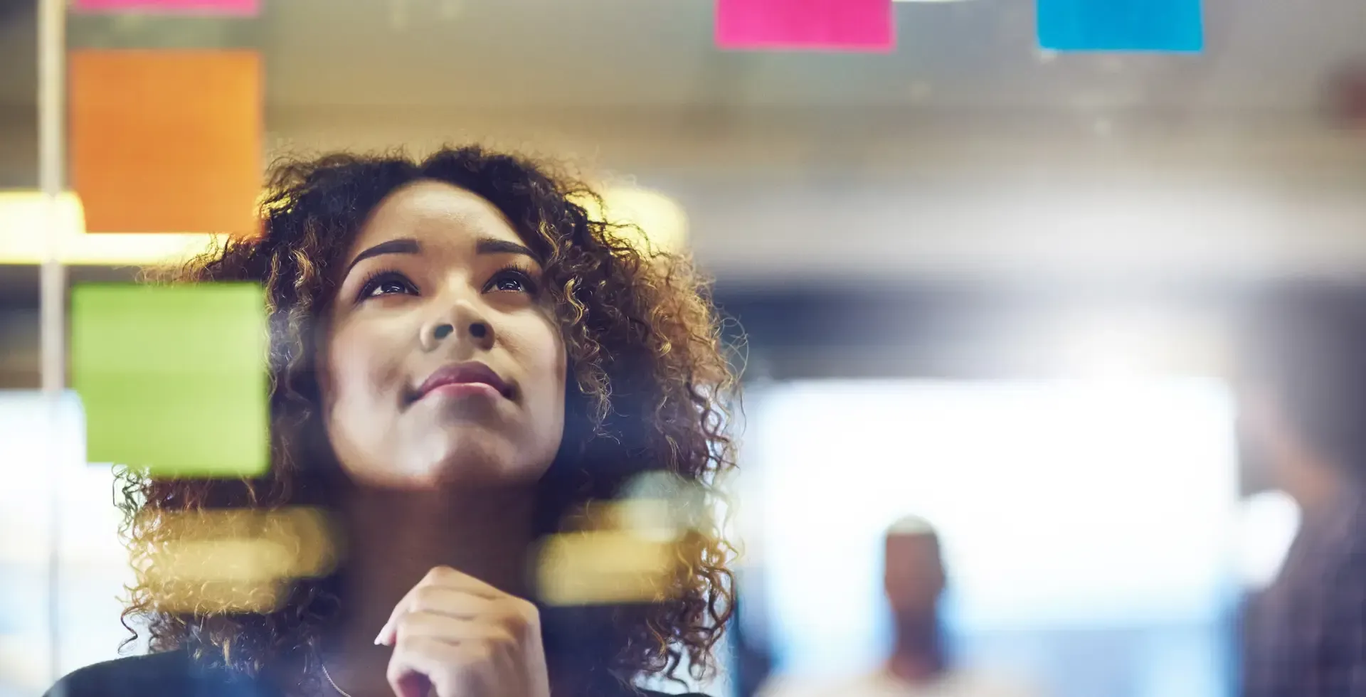 young woman brainstorming with sticky notes