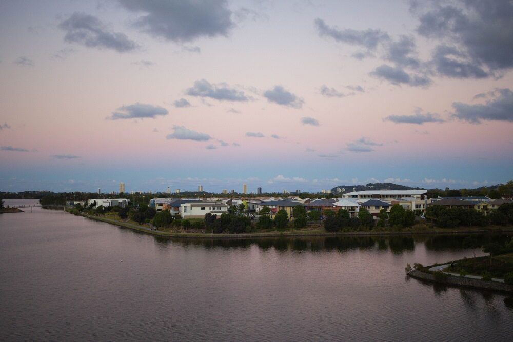An Aerial View Of A Lake With A City In The Background At Sunset — Mudgeeraba Landscape Centre In Robina, QLD