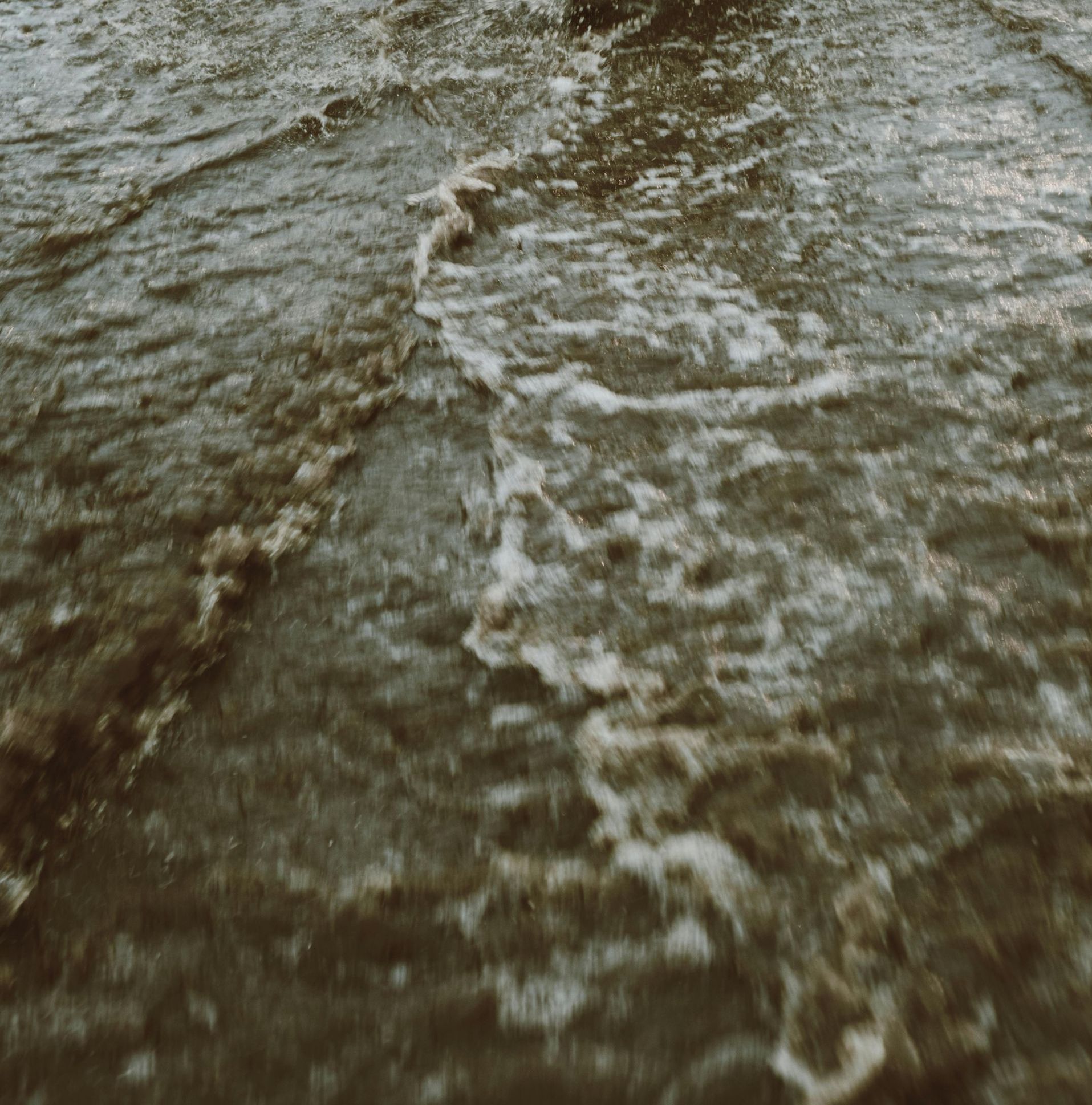 A close up of a body of water with waves