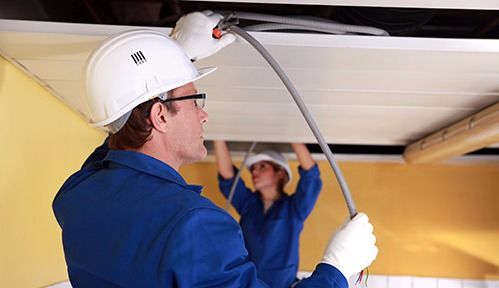 Professional reinstalling electrical wiring in the house