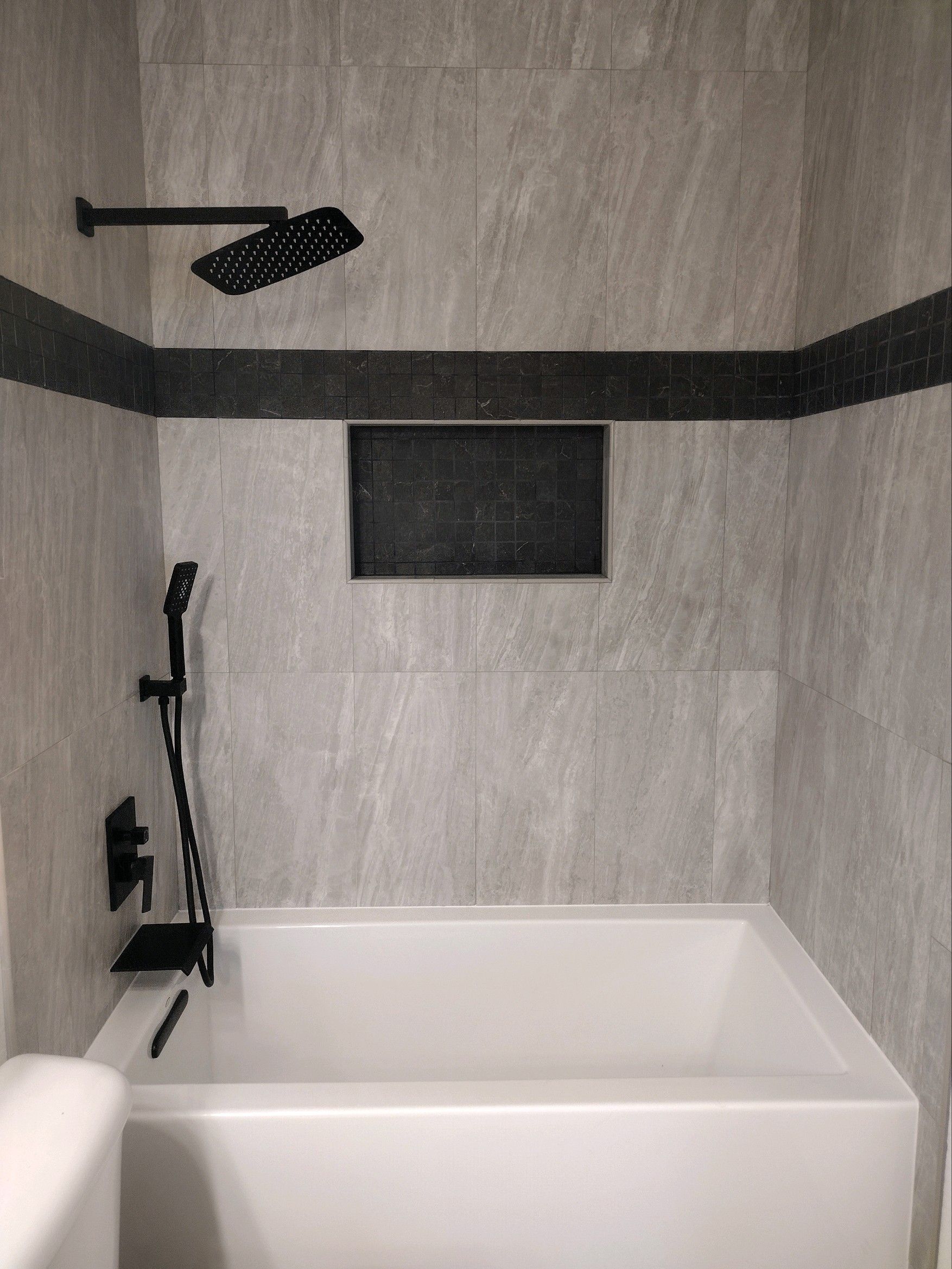 a bathroom with a bathtub and a shower head