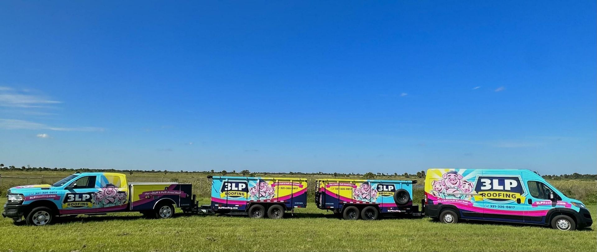 A row of four matching, brightly colored vehicles and trailers with 