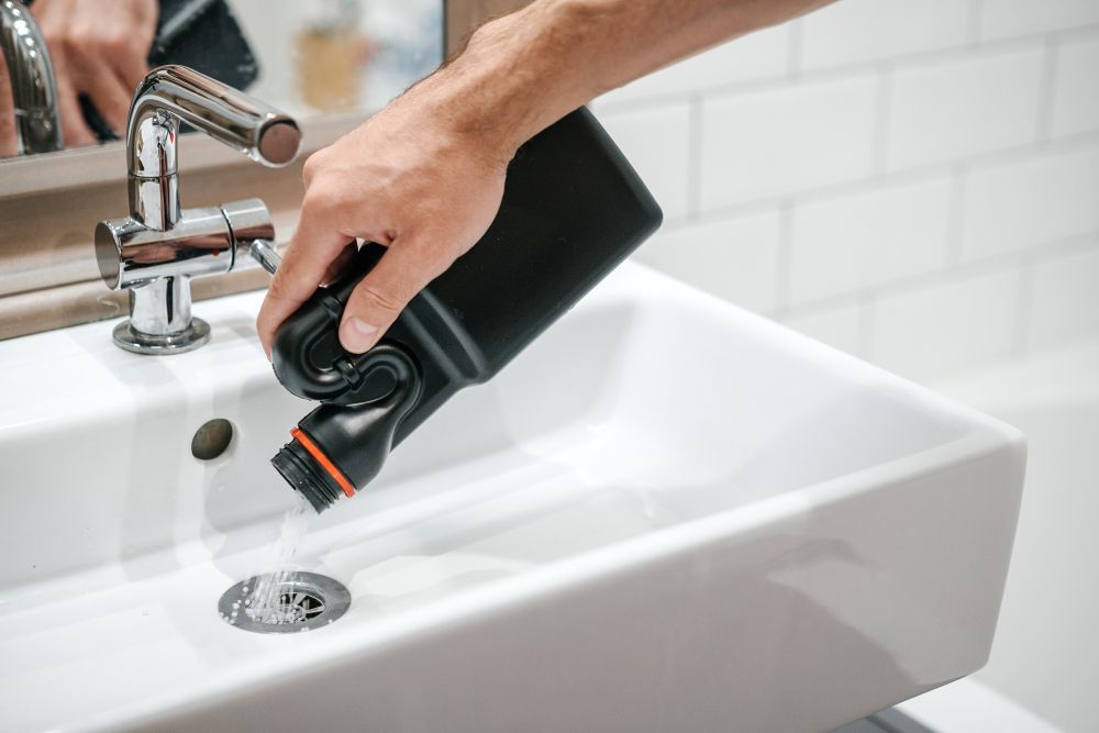 Plumber Fixing White Sink Pipe With Adjustable Wrench — Full On Plumbing & Gas In Winnellie NT