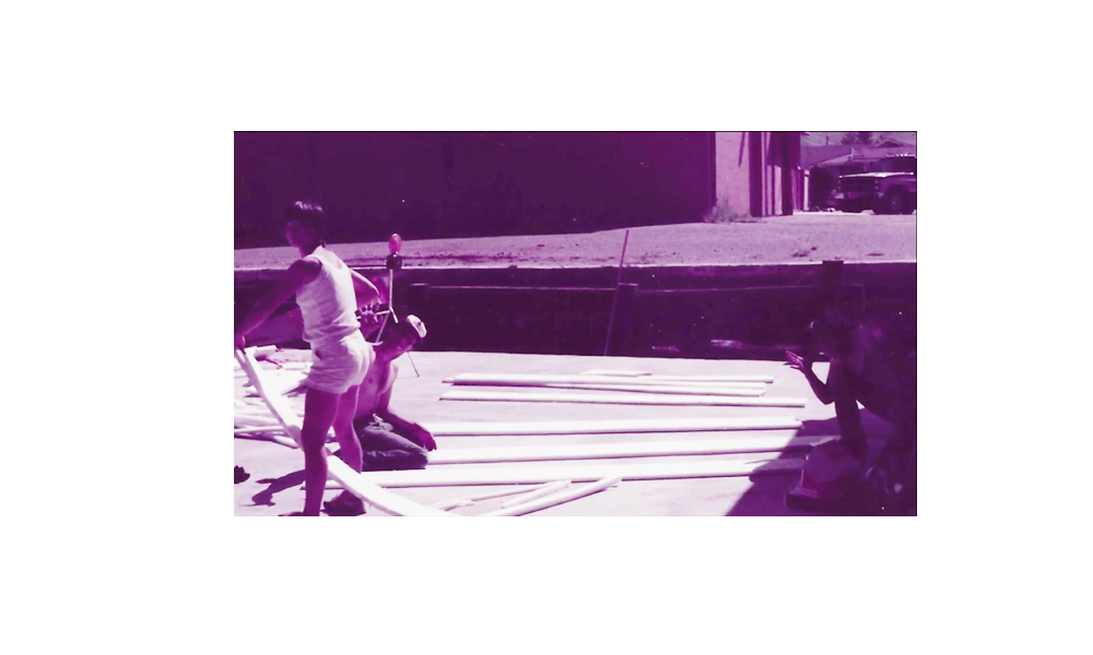 A purple and white photo of a person standing on a skateboard.