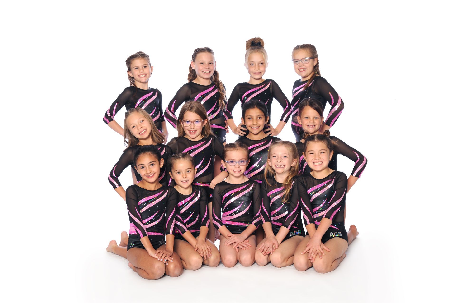 A group of young girls posing for a picture with their arms crossed