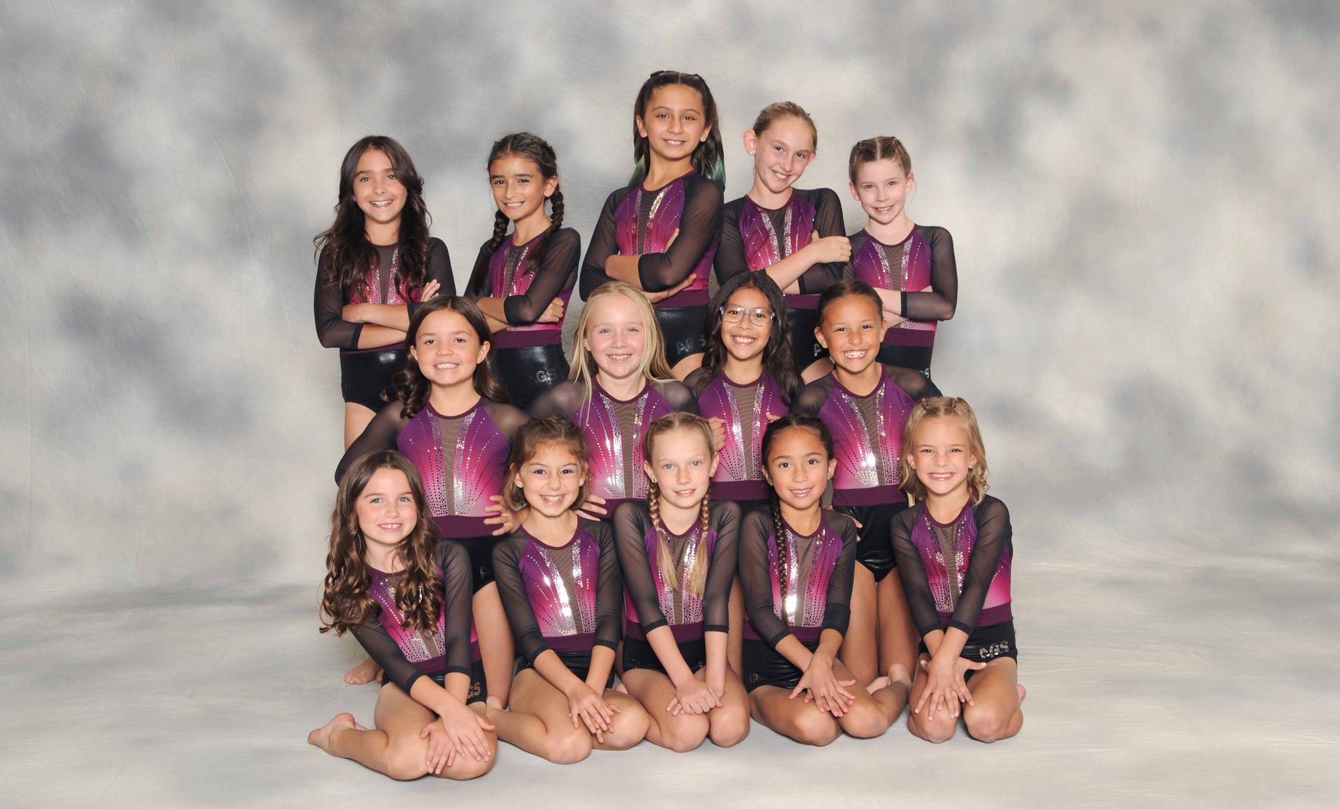 A group of young girls are posing for a picture.
