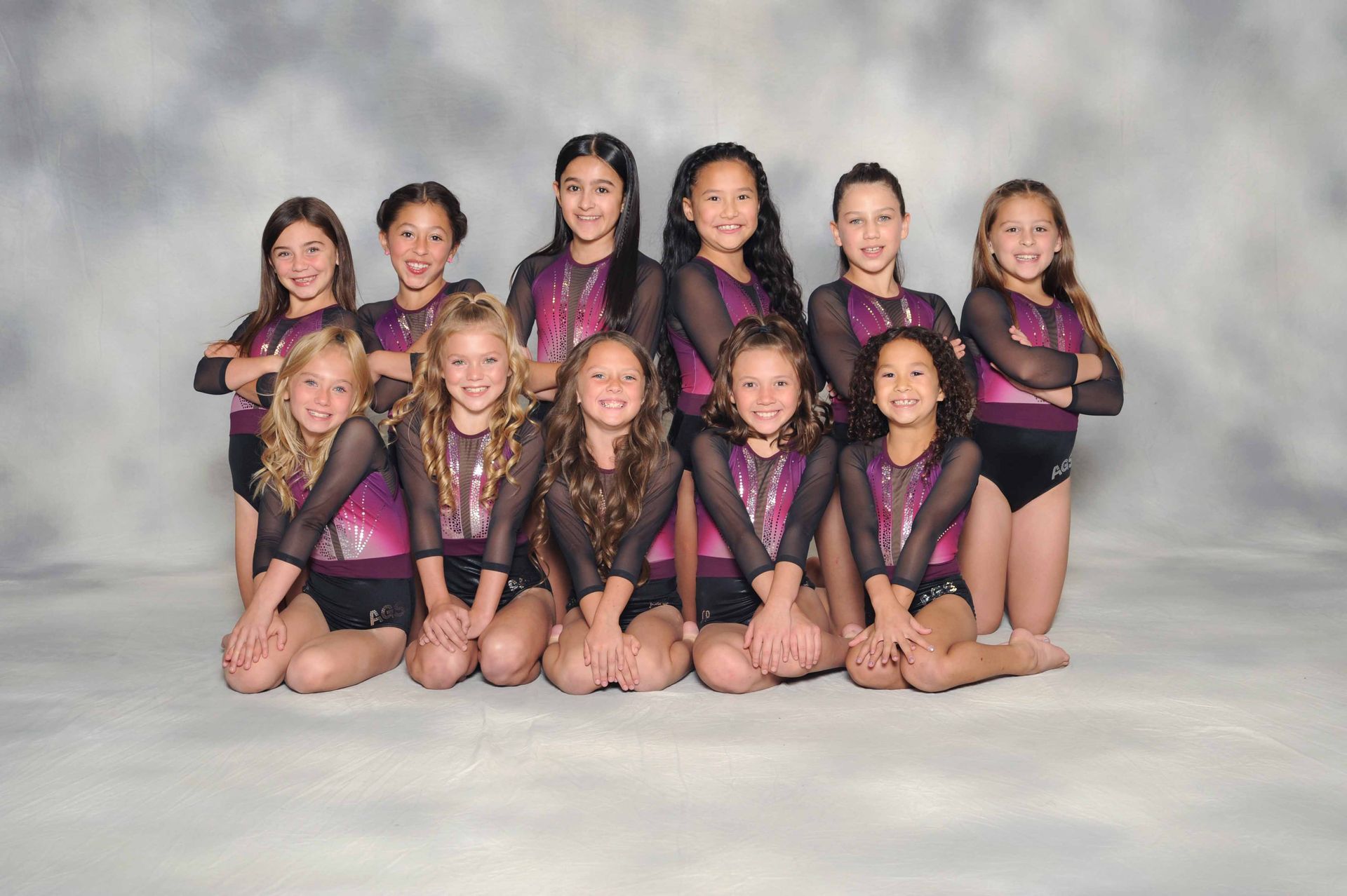 A group of young girls are posing for a picture.