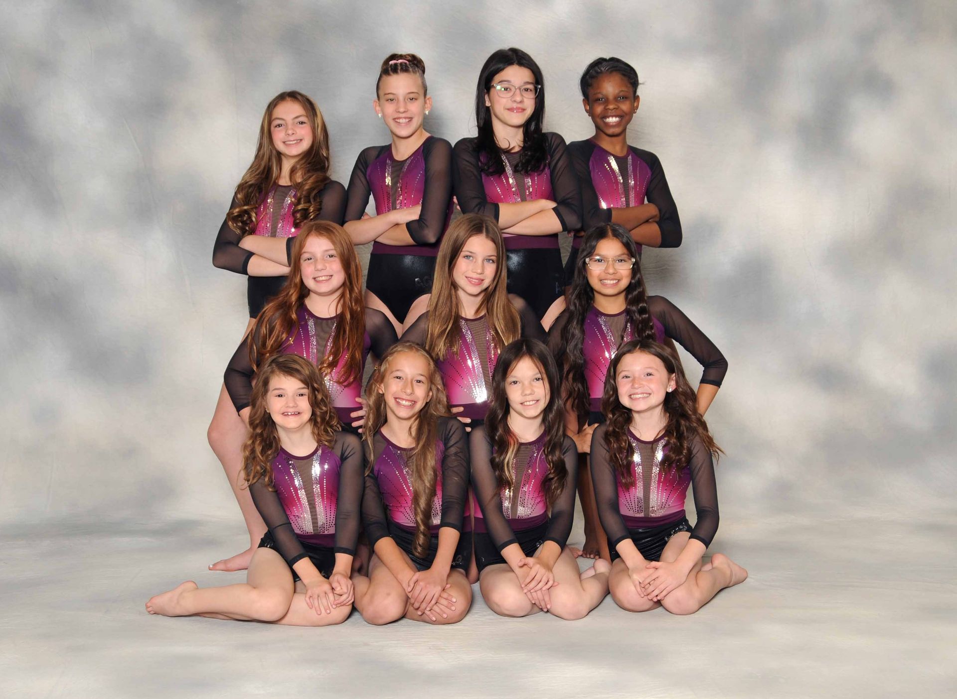 A group of young girls are posing for a picture together.