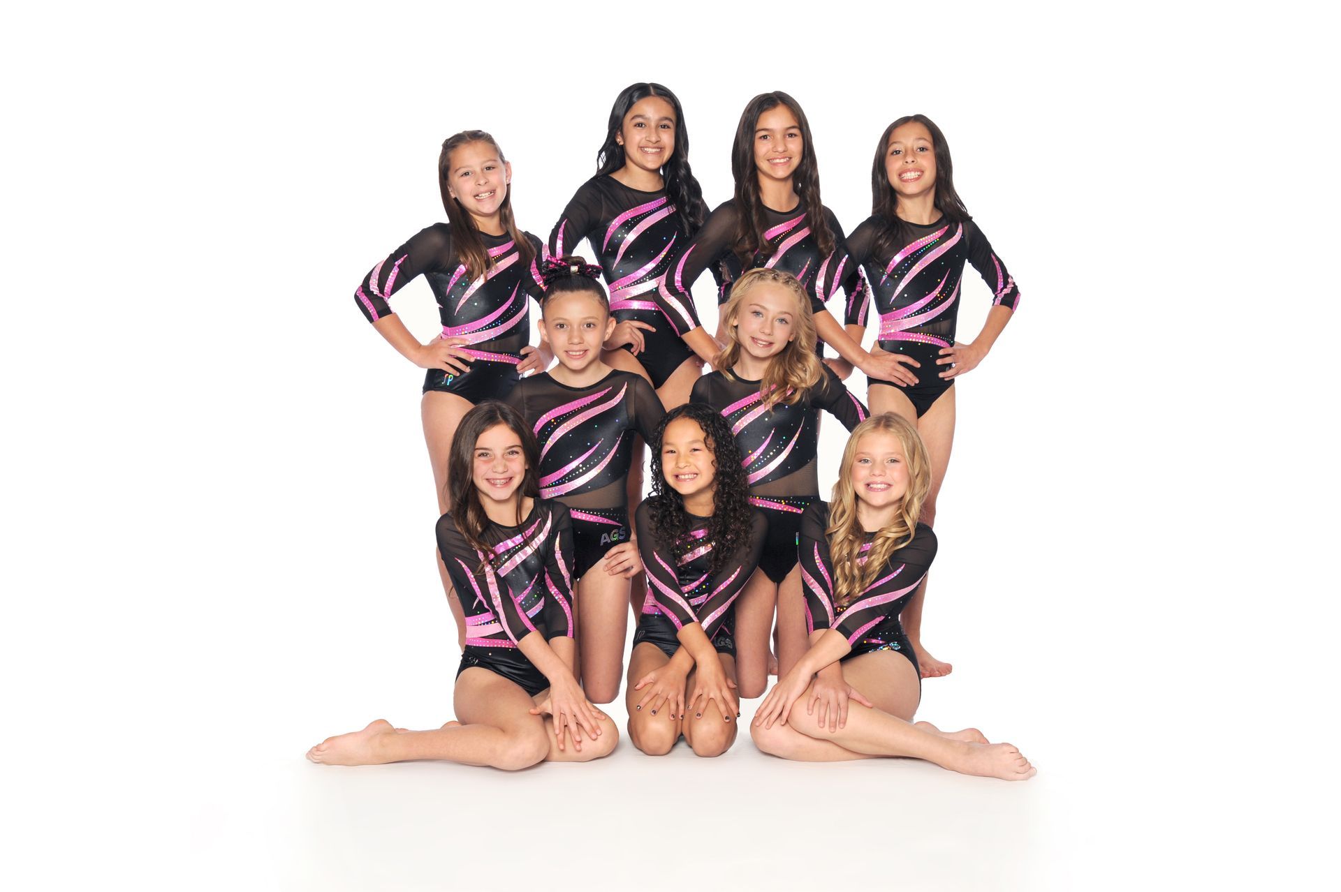A group of young girls are posing for a picture together.