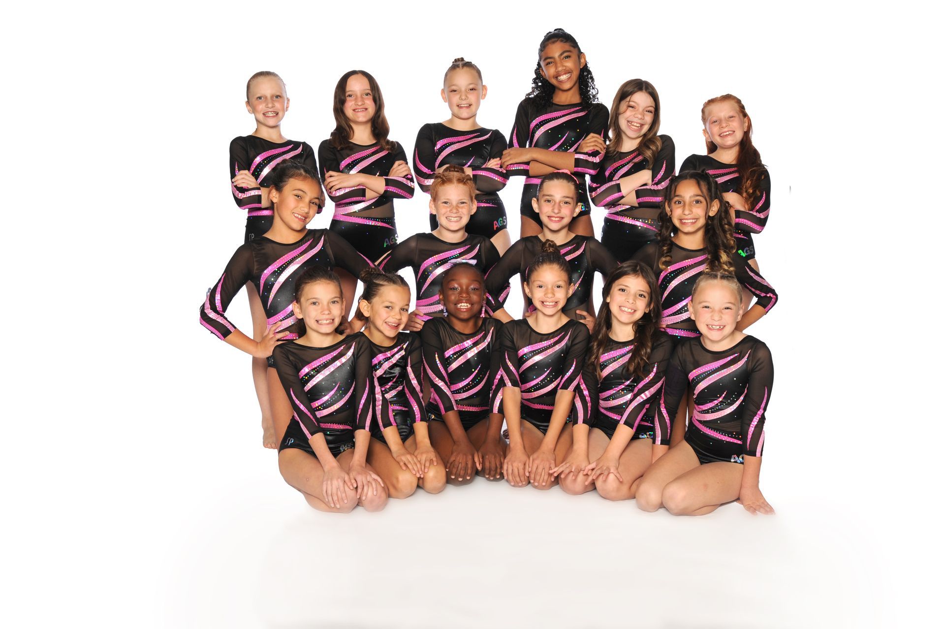 A group of young girls posing for a picture with their arms crossed