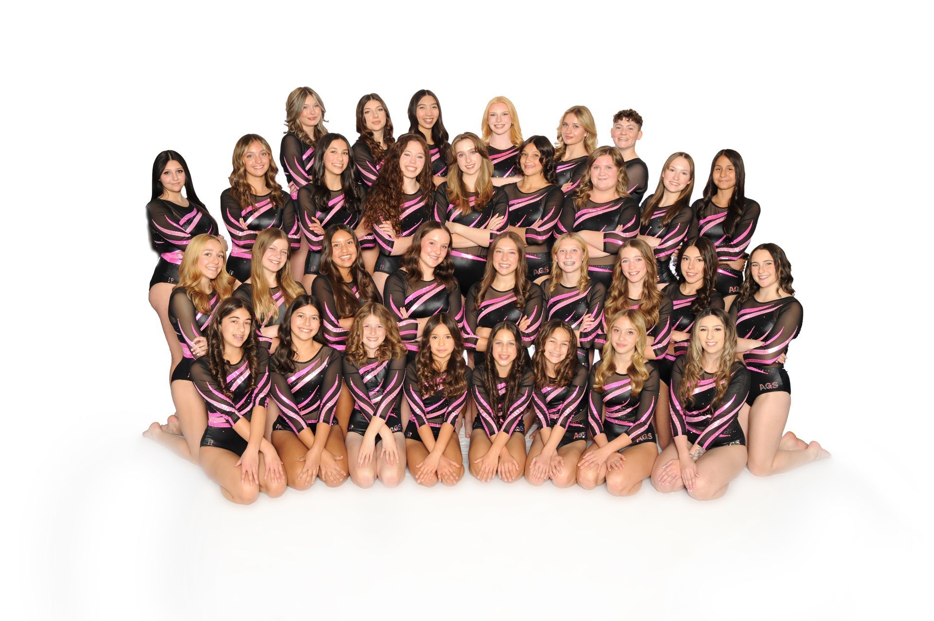 A group of young girls are posing for a picture.