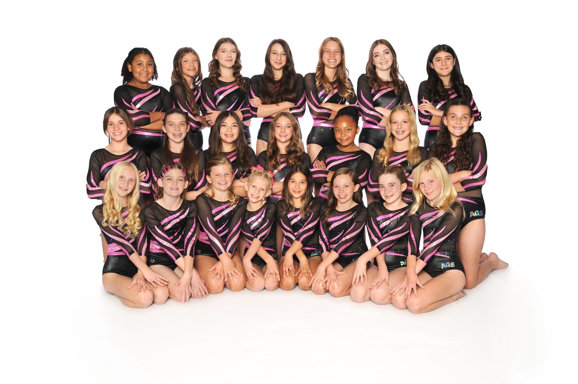 A group of young girls are posing for a picture.