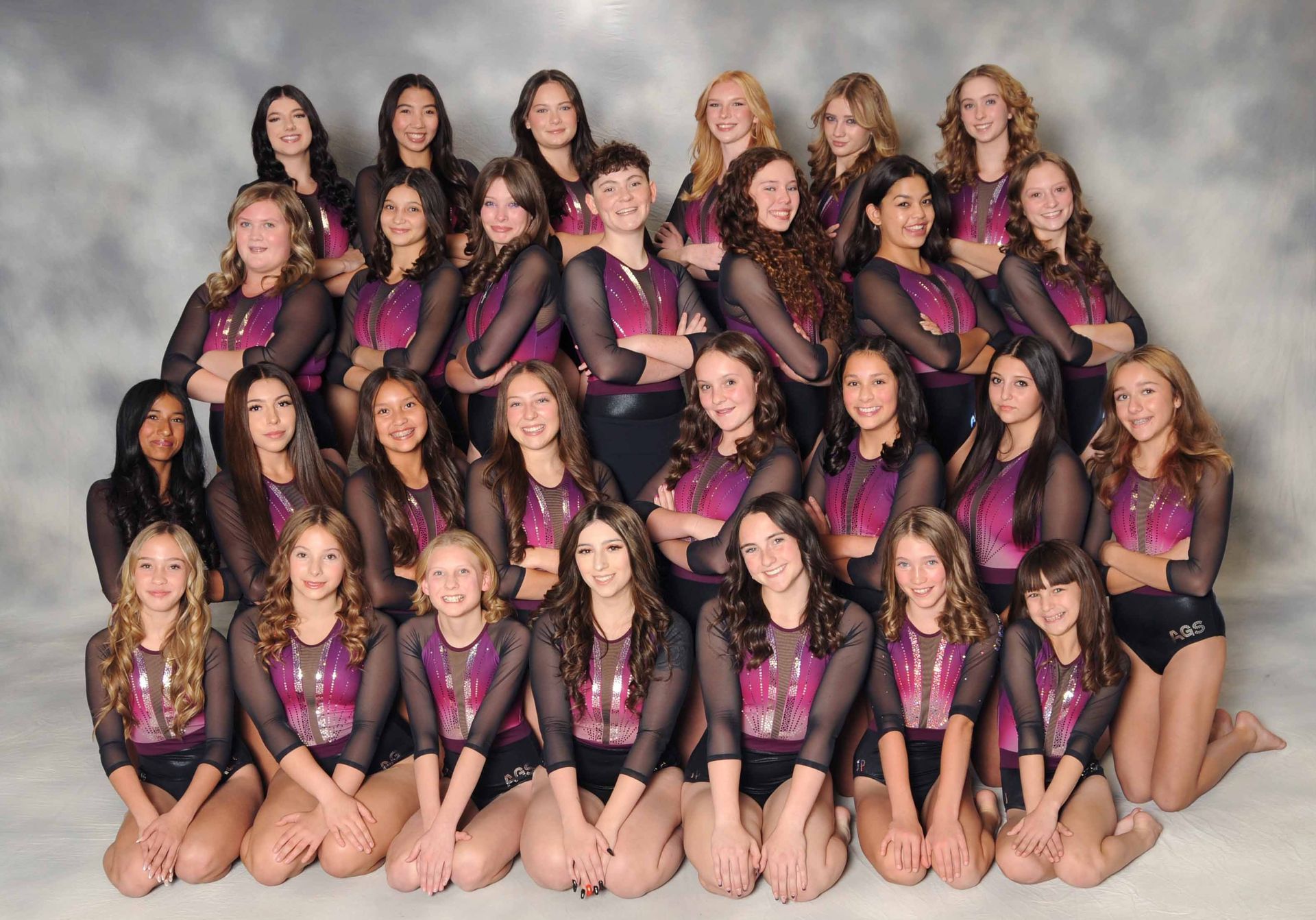 A group of young girls are posing for a picture.