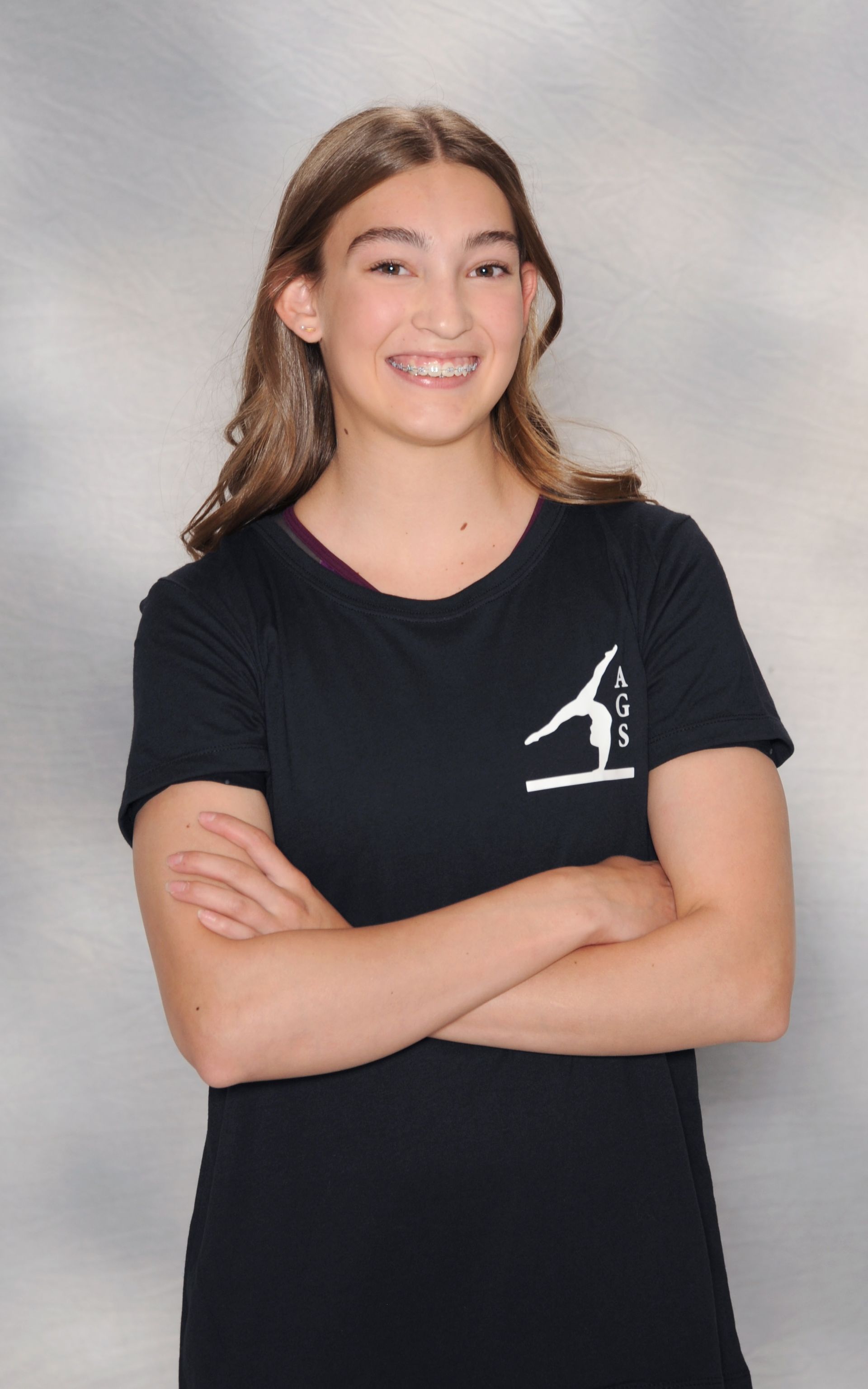 A girl wearing a black t-shirt with the letter s on it