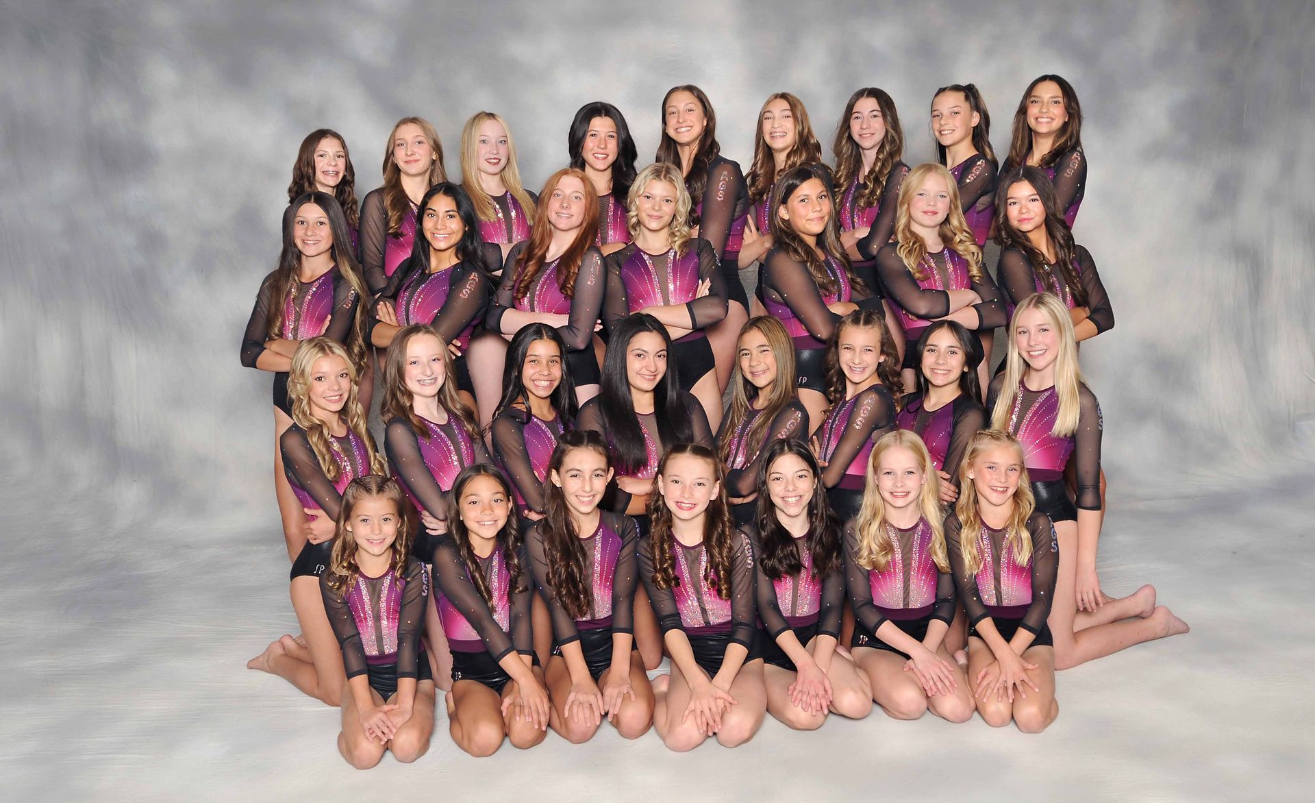 A group of young girls are posing for a picture.