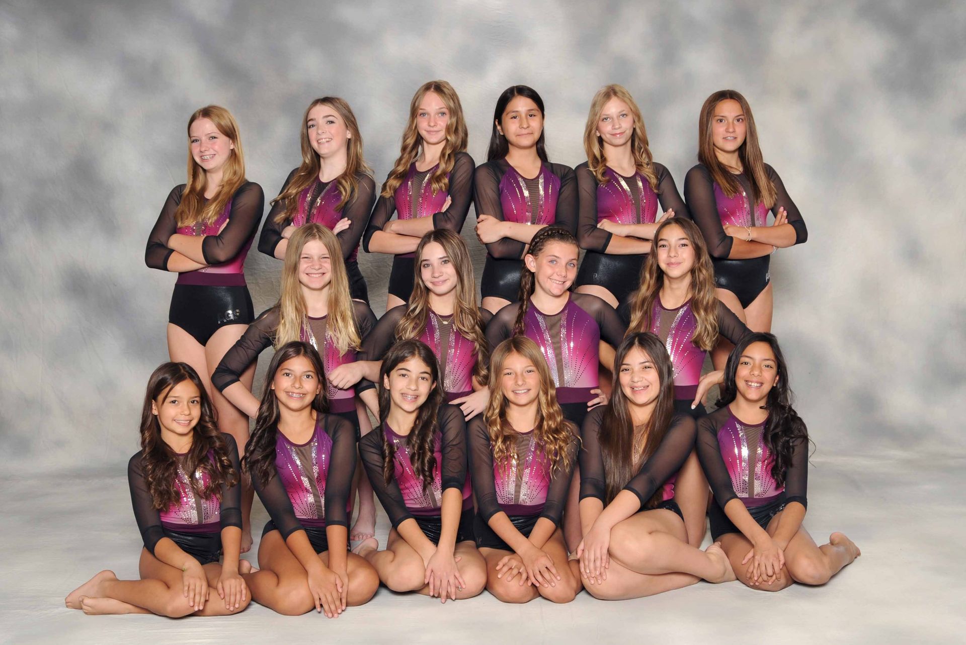 A group of young girls are posing for a picture.