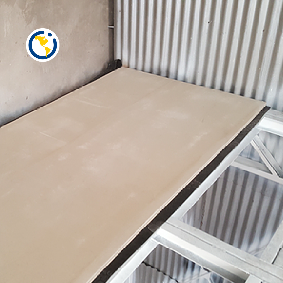 Un trozo de cartón está en una habitación junto a una pared de metal.