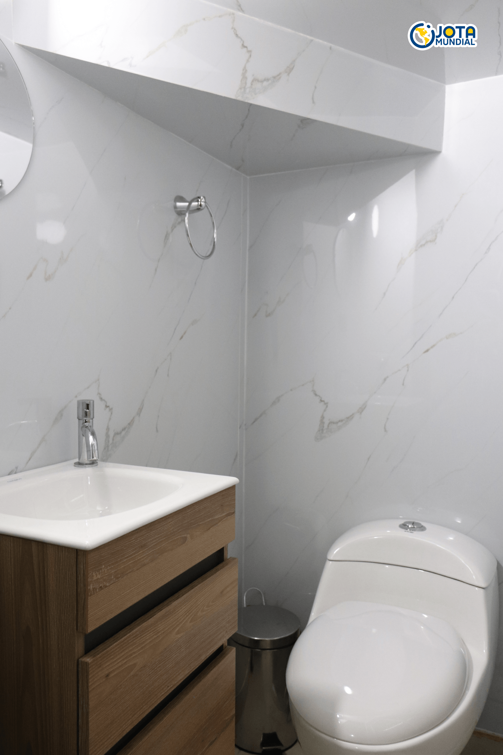 Un baño con inodoro, lavabo y espejo.