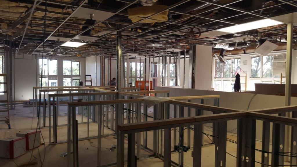 Interior of a construction site with exposed ceiling, metal frames, and unfinished walls.
